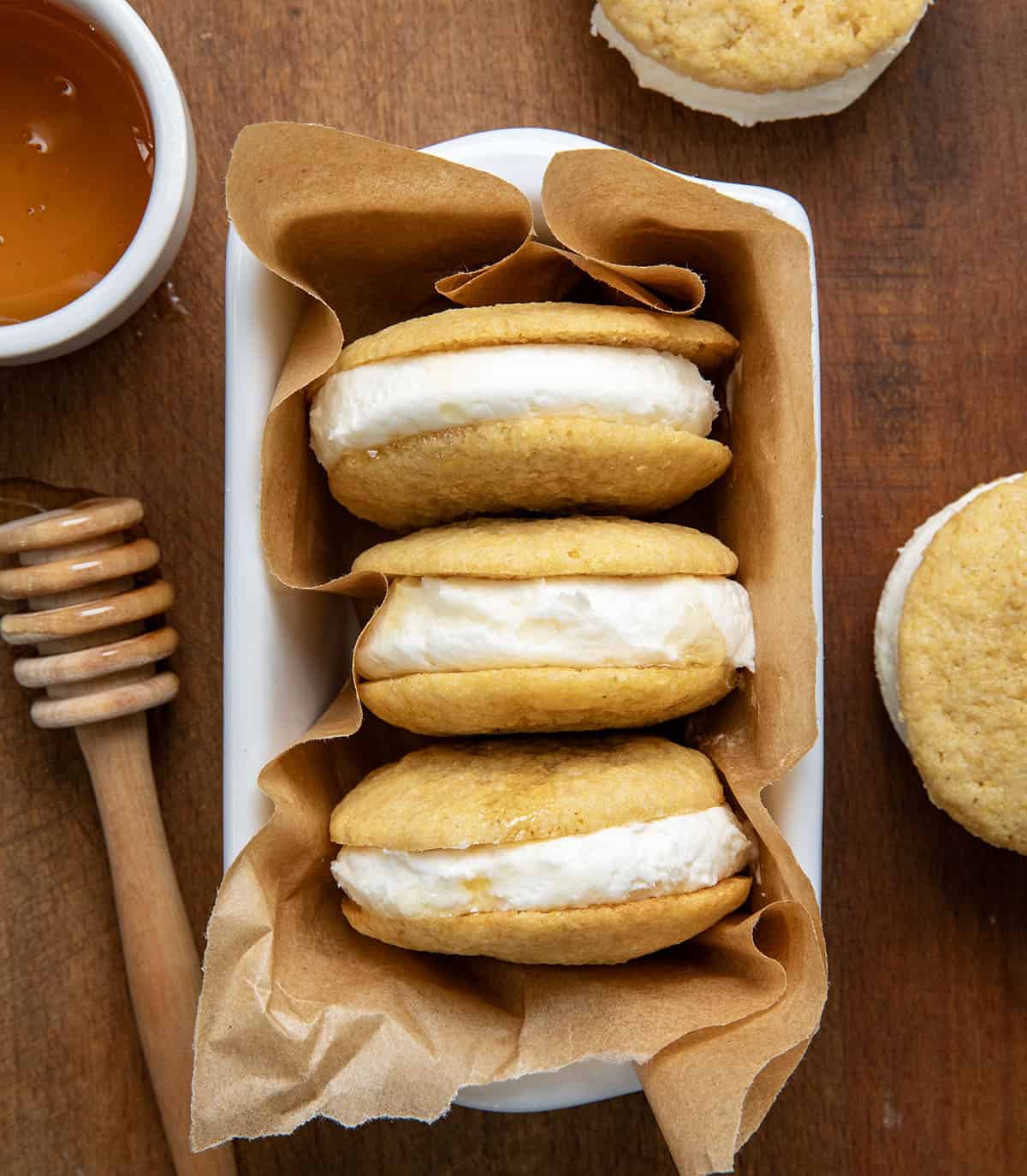 Pan with Cornbread Sandwich Cookies in it on a wooden table from overhead.