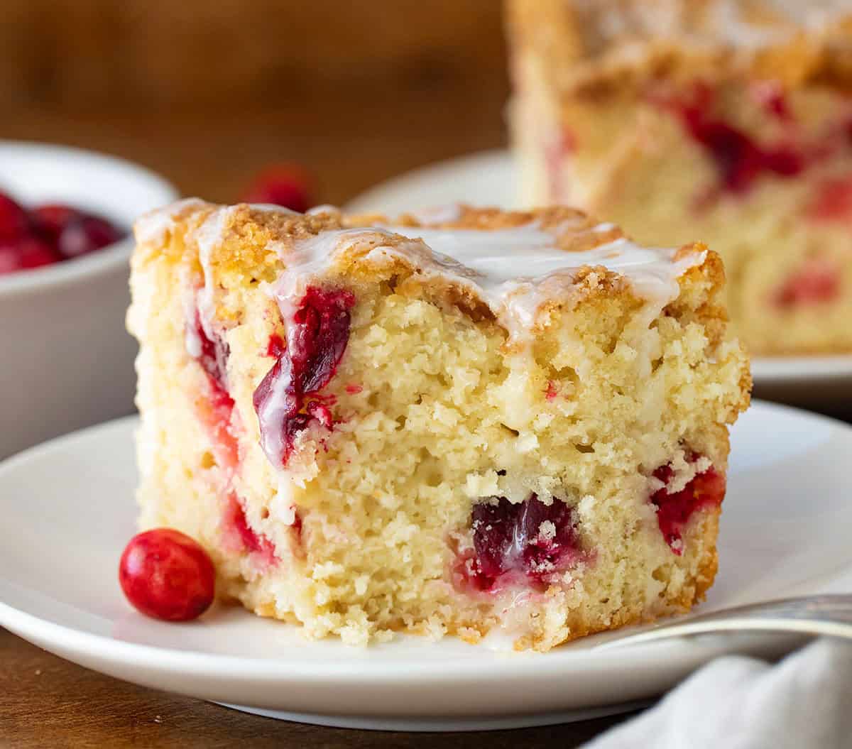 Piece of Cranberry Coffee Cake with a bite removed.