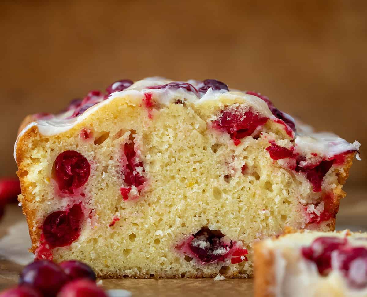 Cut into loaf of Cranberry Orange Loaf straight on and close up.