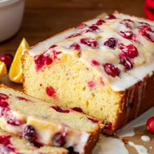 Cranberry Orange Loaf on a table with a few pieces cut off and laying flat.