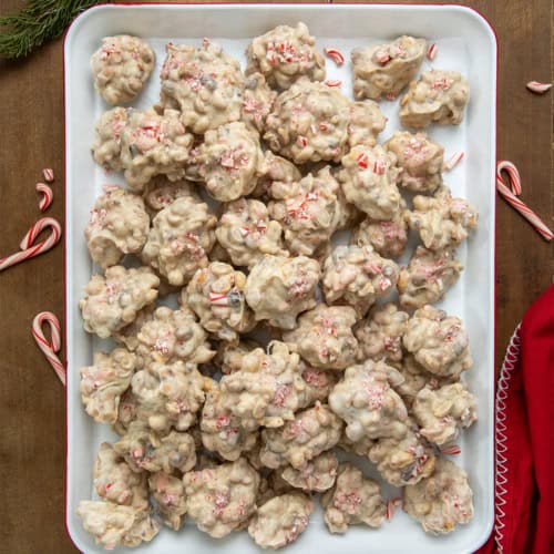 Tray of Crockpot Christmas Candy on a wooden table from overhead.