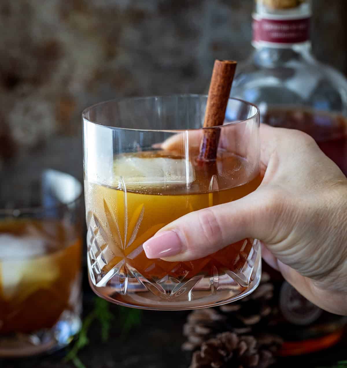 Hand holding a Gingerbread Old Fashioned.