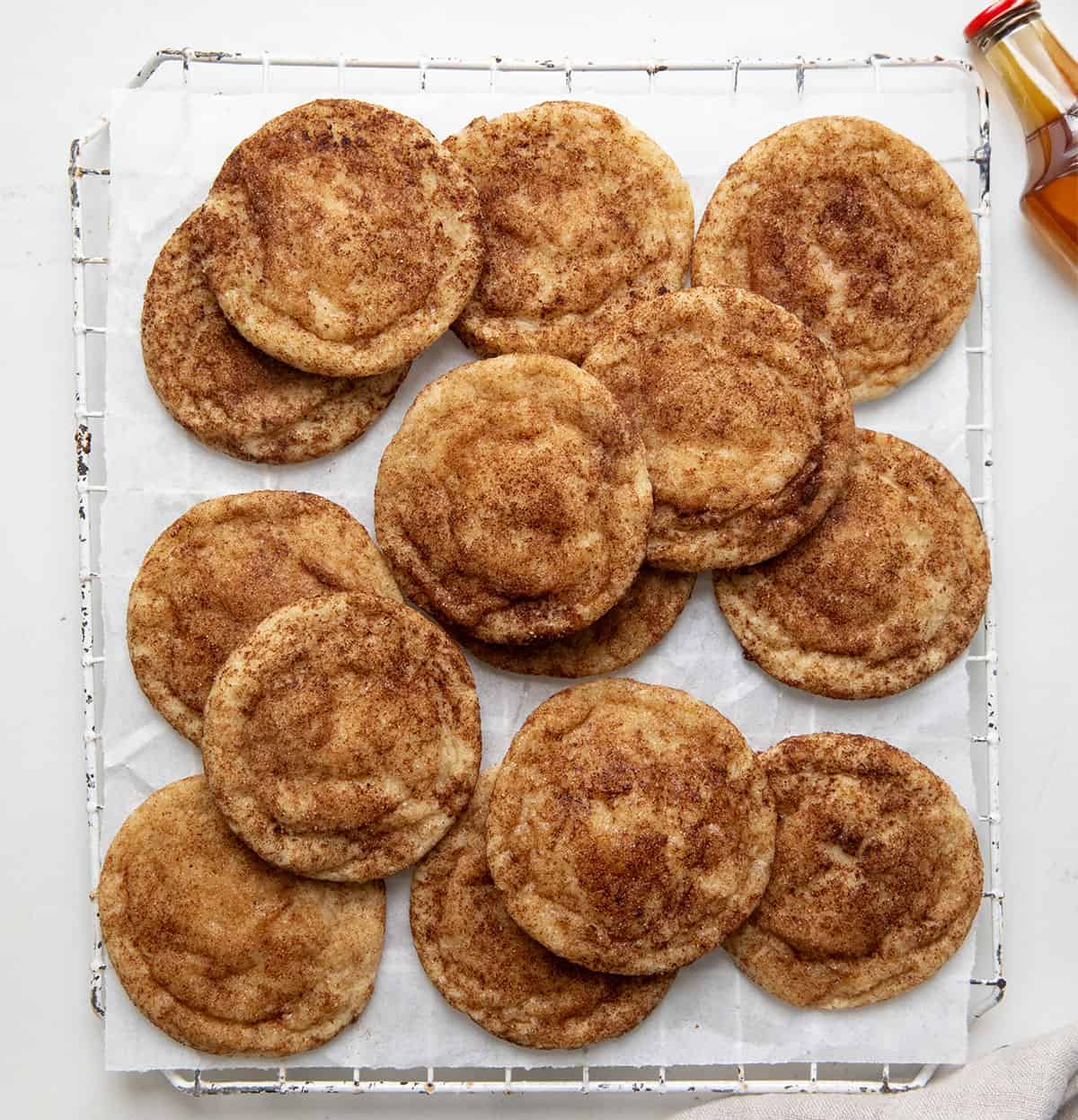 White wire rack with Maple Snickerdoodles on it on a white table from overhead.