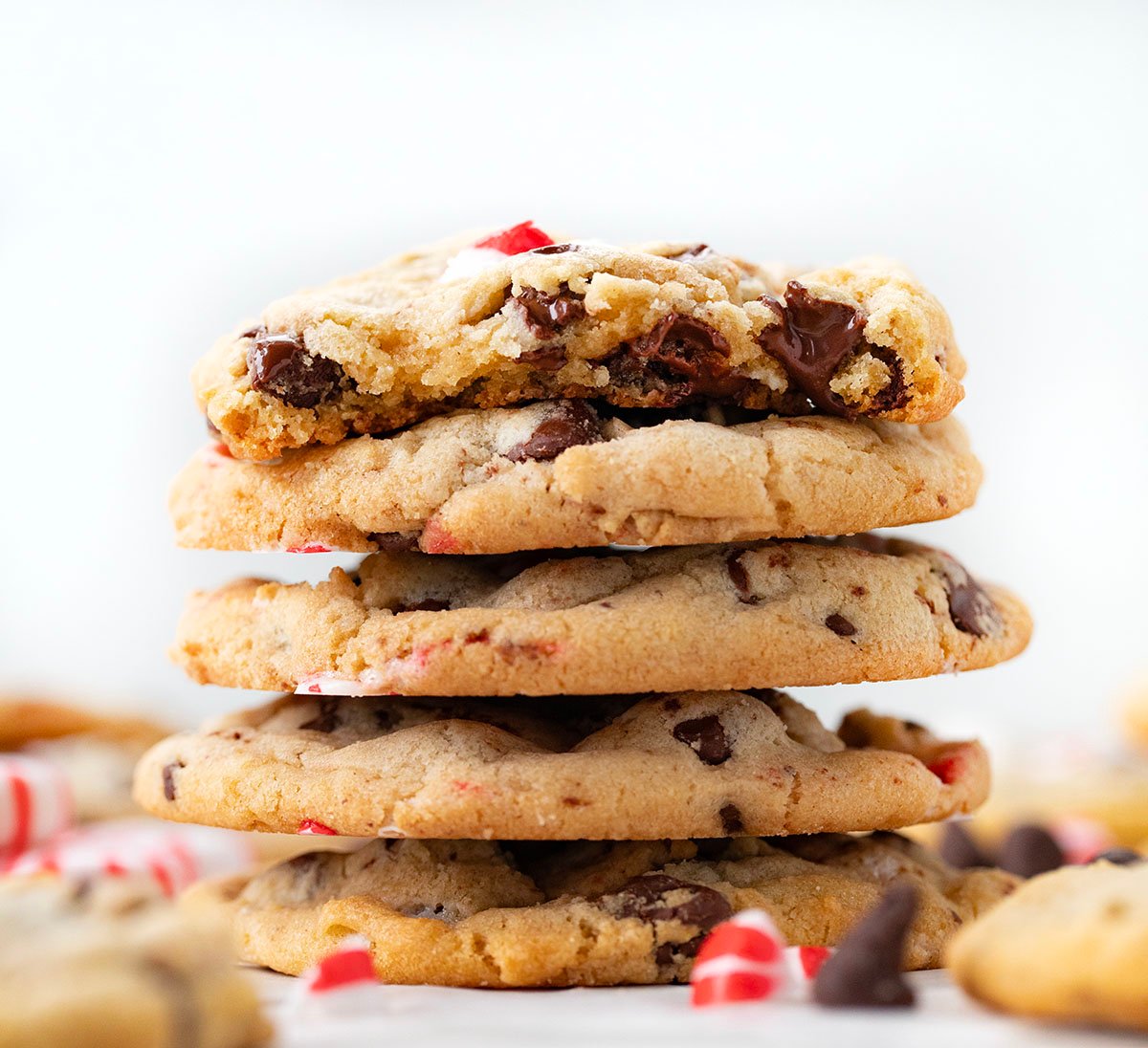 Stack of Peppermint Chocolate Chip Cookies with top cookie half eaten.