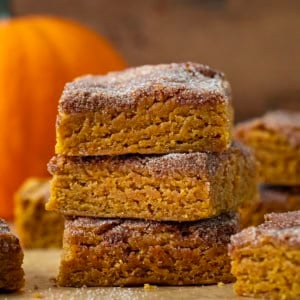 Stack of Pumpkin Snickerdoodle Brownies on a wooden table.