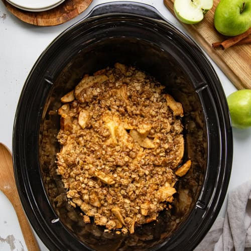 Slow Cooker Apple Crisp on a white table from overhead.