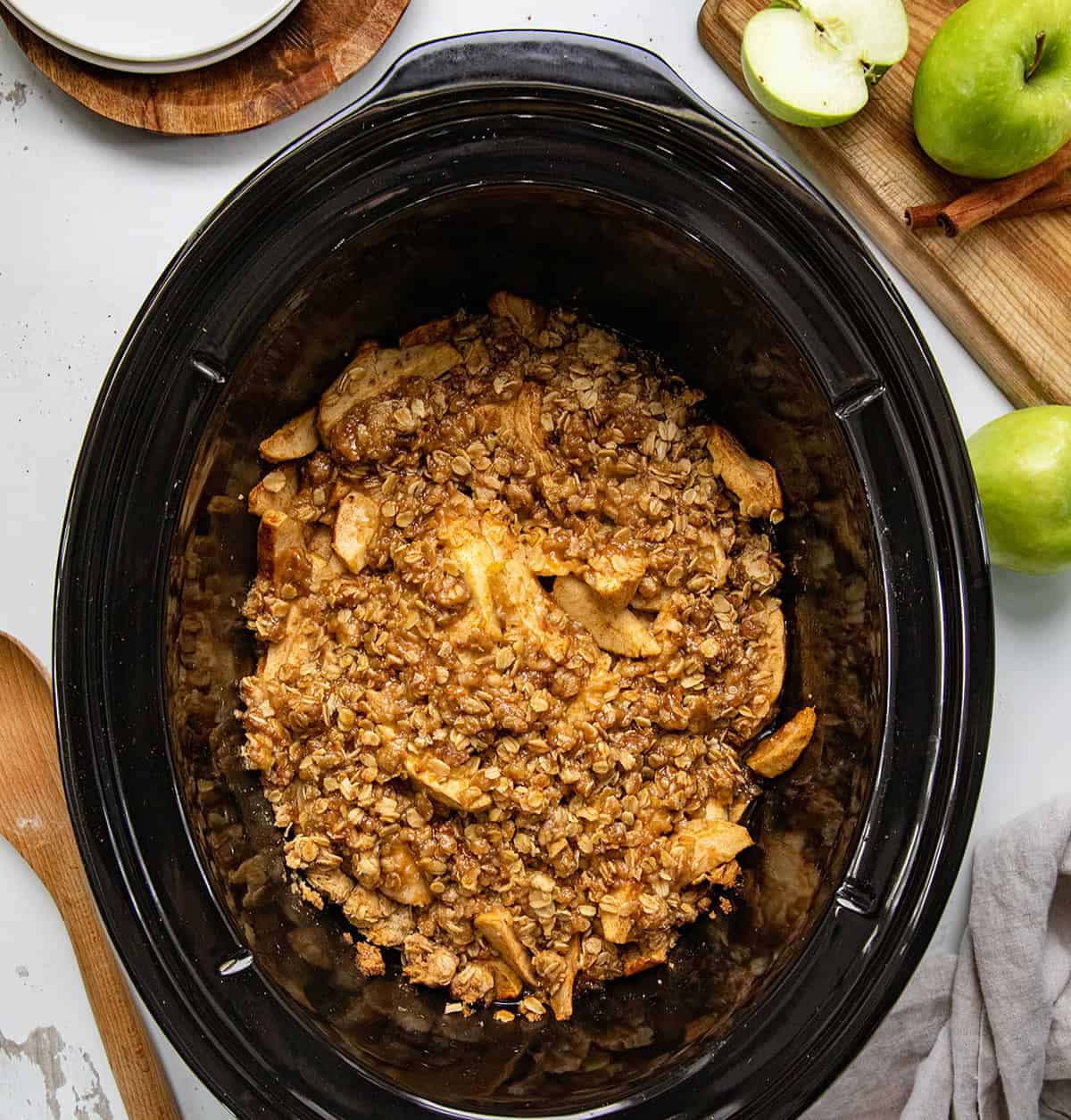 Slow Cooker Apple Crisp on a white table from overhead.