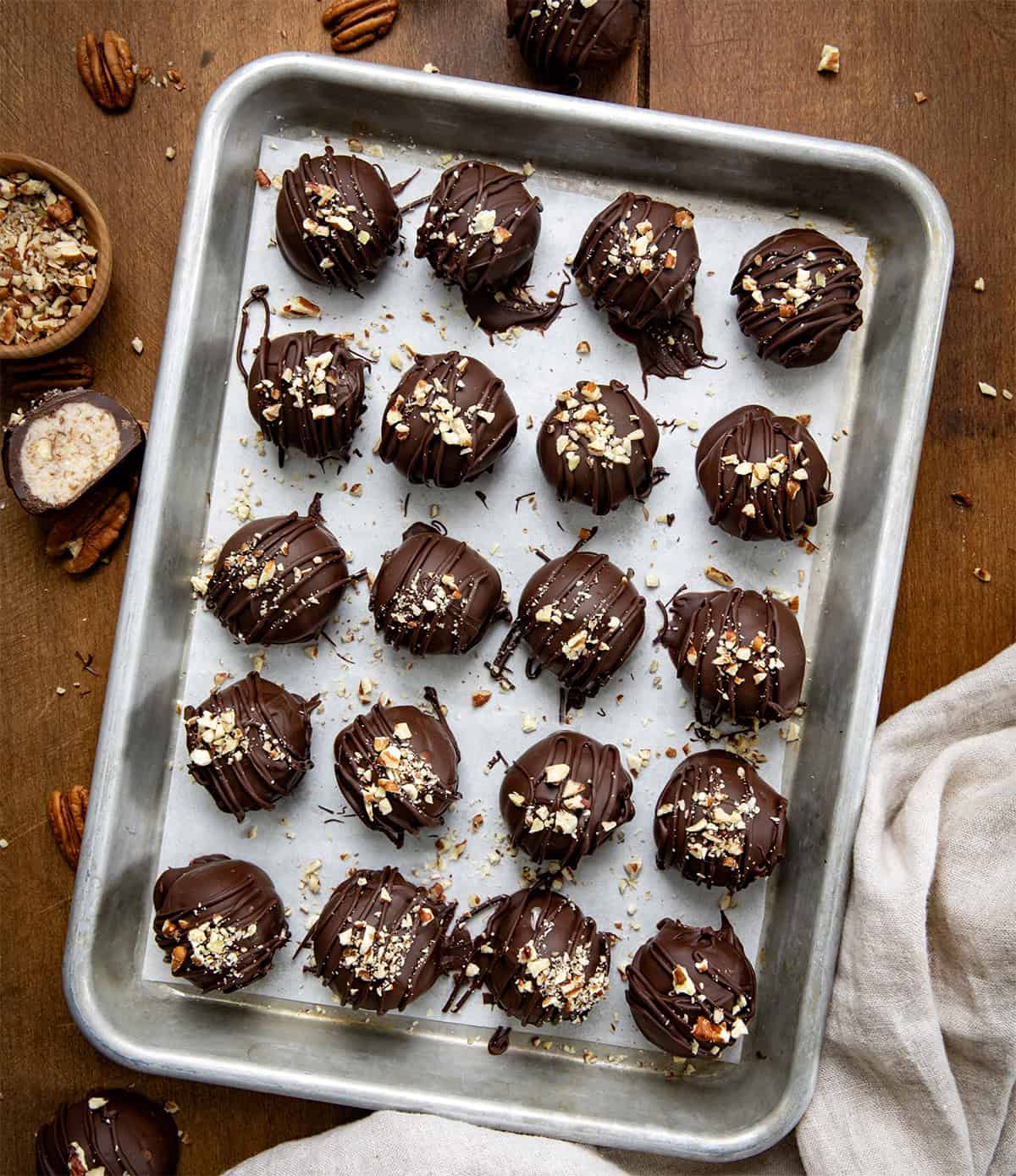 Bourbon Balls on a tray on a wooden table from overhead. 