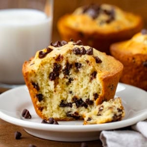 Bit into Bakery Style Chocolate Chip Muffin on a plate showing tender inside.