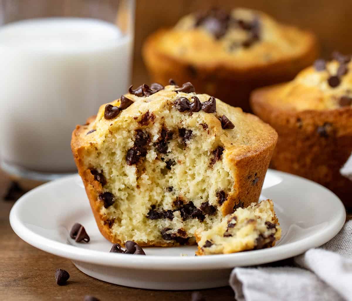 Bit into Bakery Style Chocolate Chip Muffin on a plate showing tender inside.