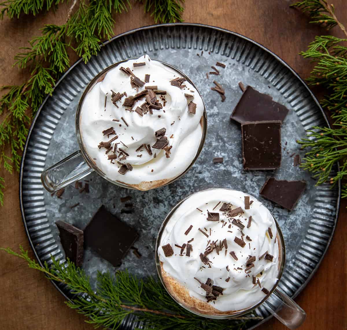 Looking down on glasses of Chocolate Eggnog on a tray on a wooden table.