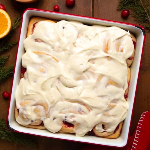 Pan of Cranberry Orange Sweet Rolls on a wooden table from overhead.