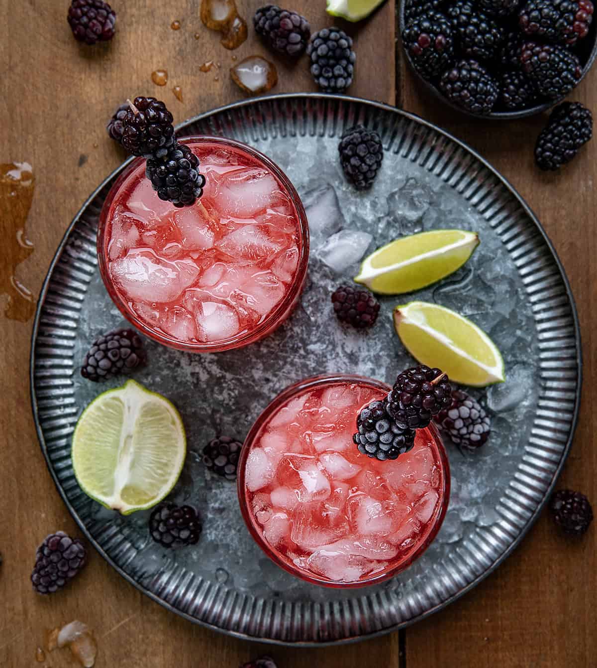 Glasses of Frosted Blackberry Bourbon Smash on a tray from overhead.