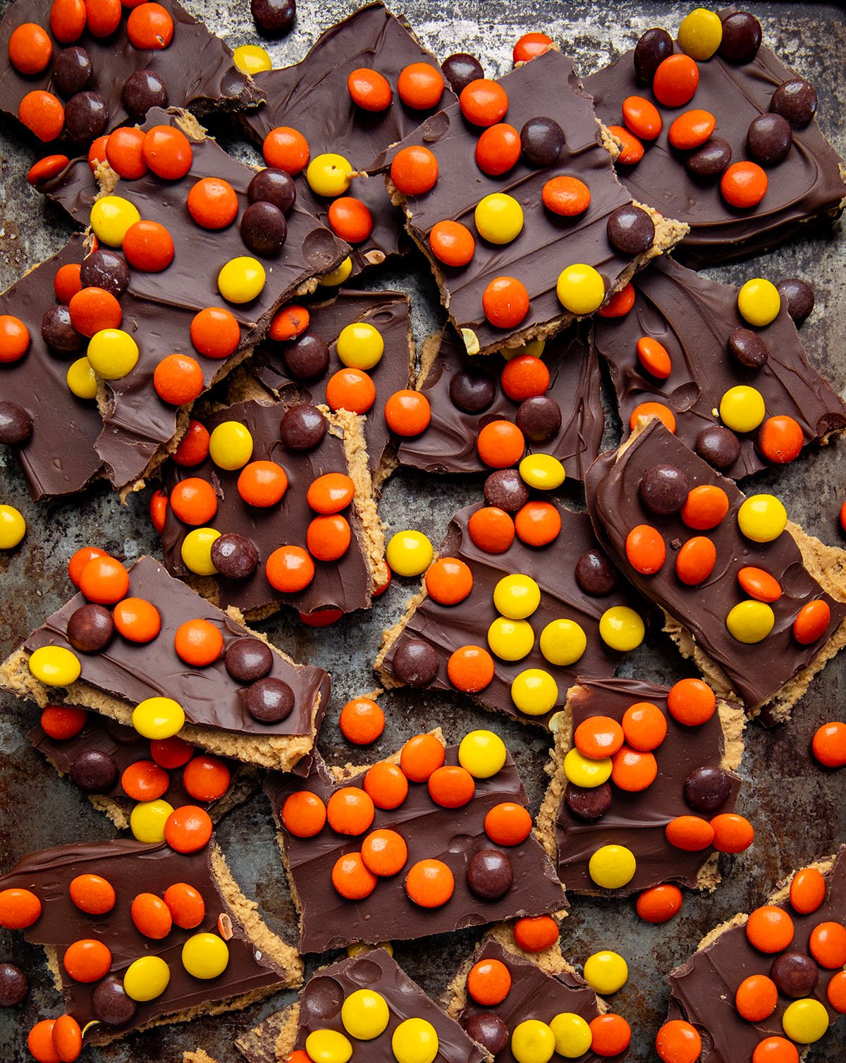 Close up of Reese's Pieces Peanut Butter Bark on a cookie sheet.