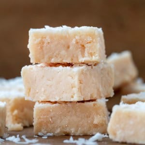 Stack of White Coconut Fudge on a wooden table.