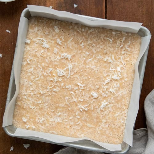 Pan of White Coconut Fudge on a wooden table from overhead.