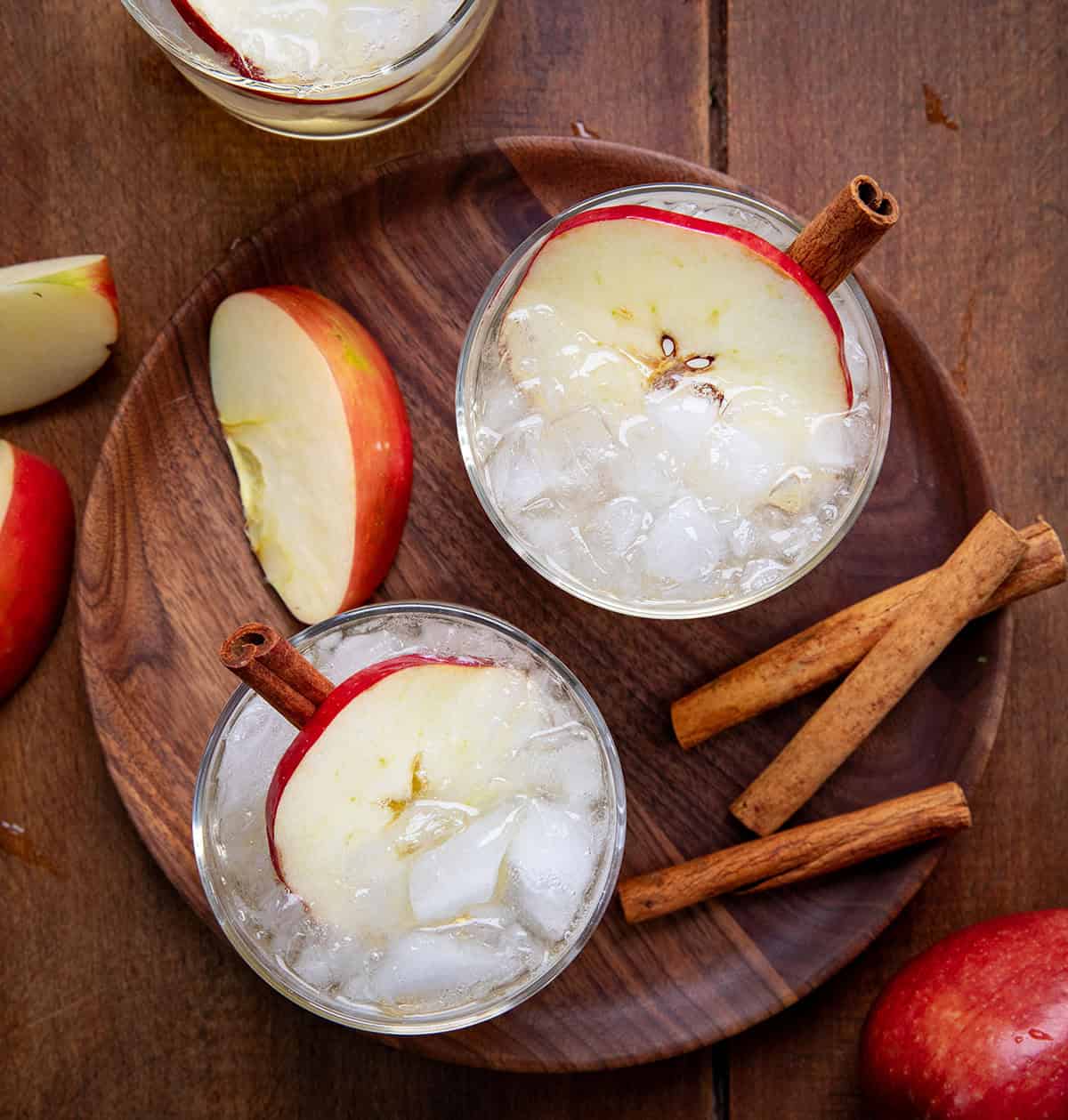 Glasses of Apple Bourbon Milk Punch on a wooden table from overhead.