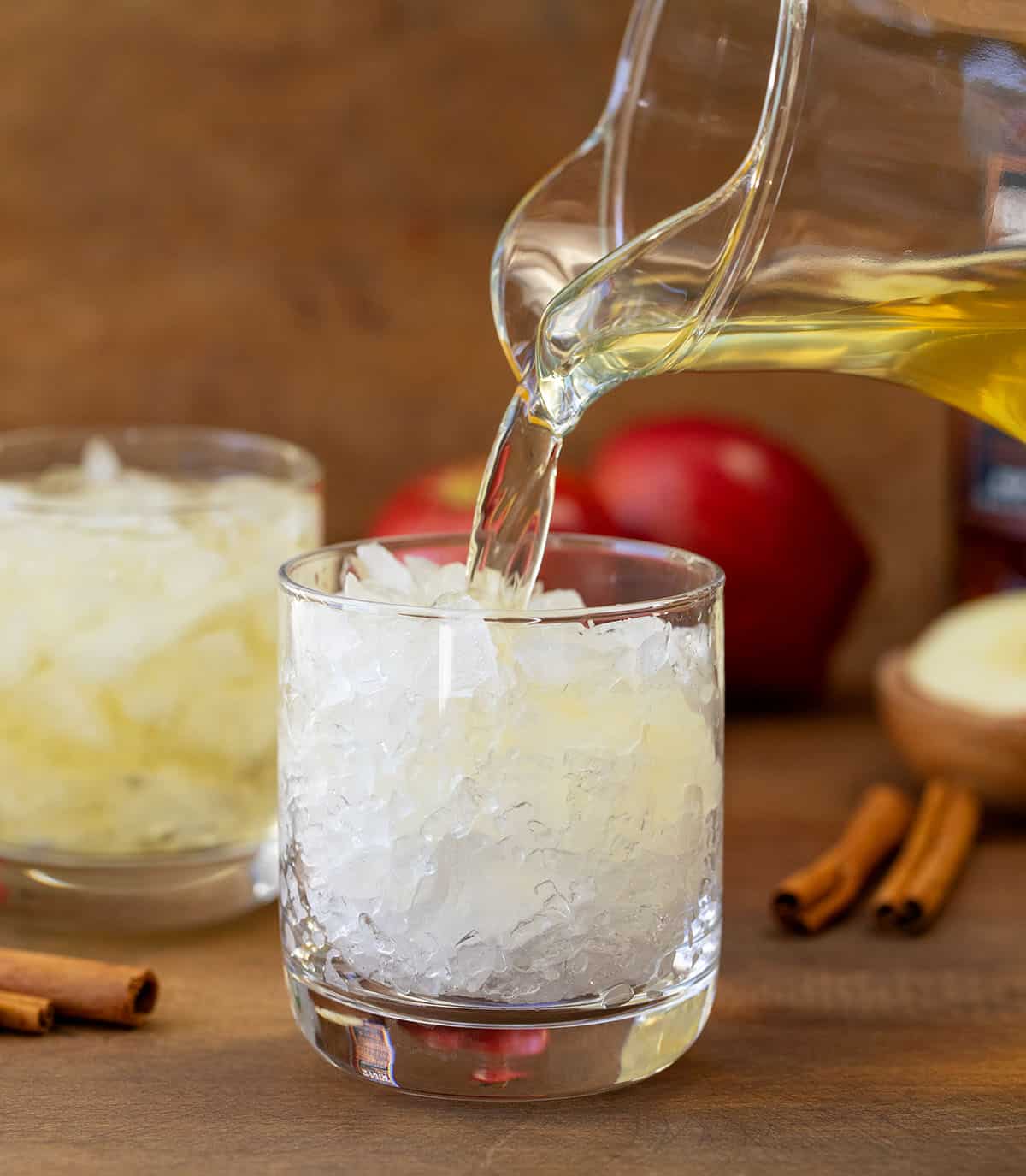 Pouring Apple Bourbon Milk Punch into a glass.