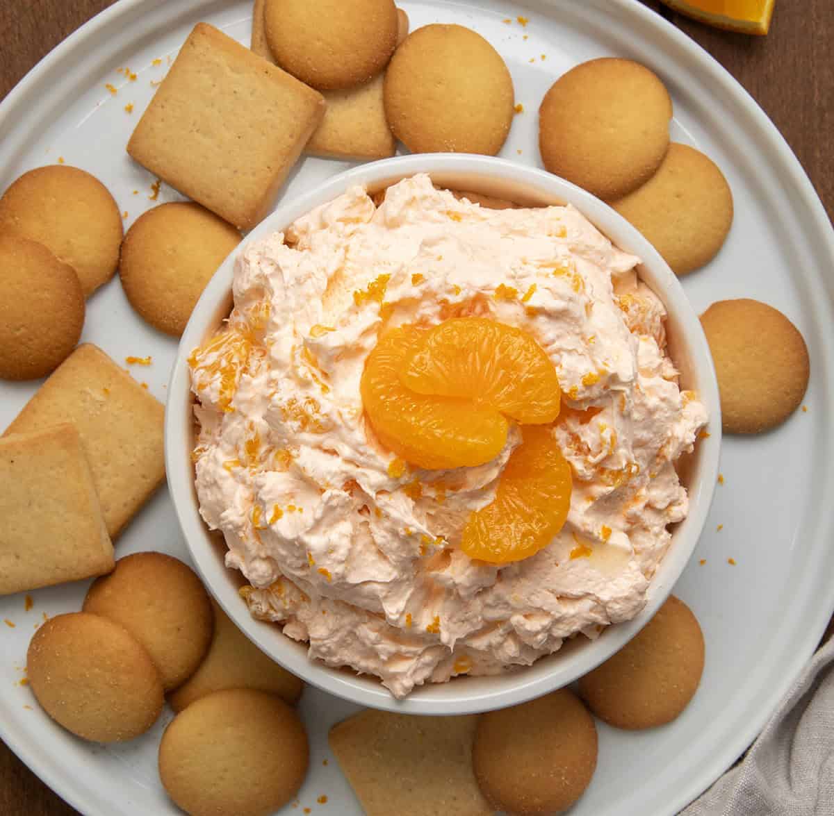 BOWL OF Orange Creamsicle Dream Dip ON a platter with vanilla wafers from overhead.