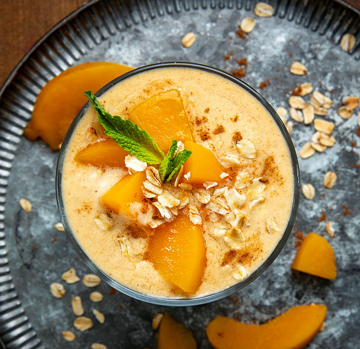 Looking down on a glass full of Peach Cobbler Smoothie.