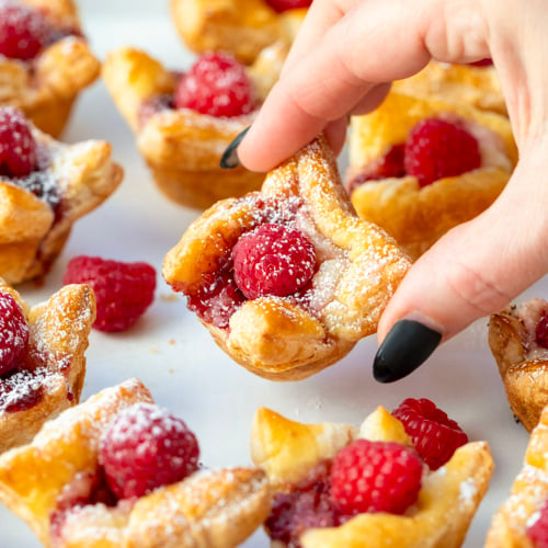 Hand picking up a Raspberry Cream Cheese Bite.