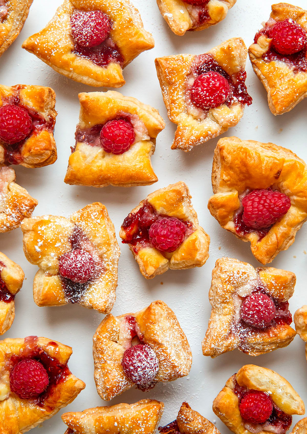 Raspberry Cream Cheese Bites on a white table shot from overhead.