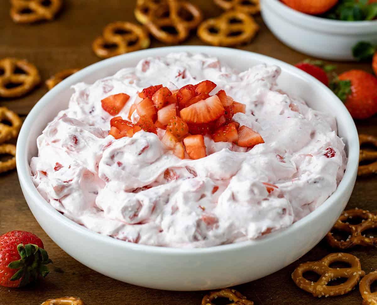 Bowl of Strawberry Dream Dip with fresh strawberries on top.