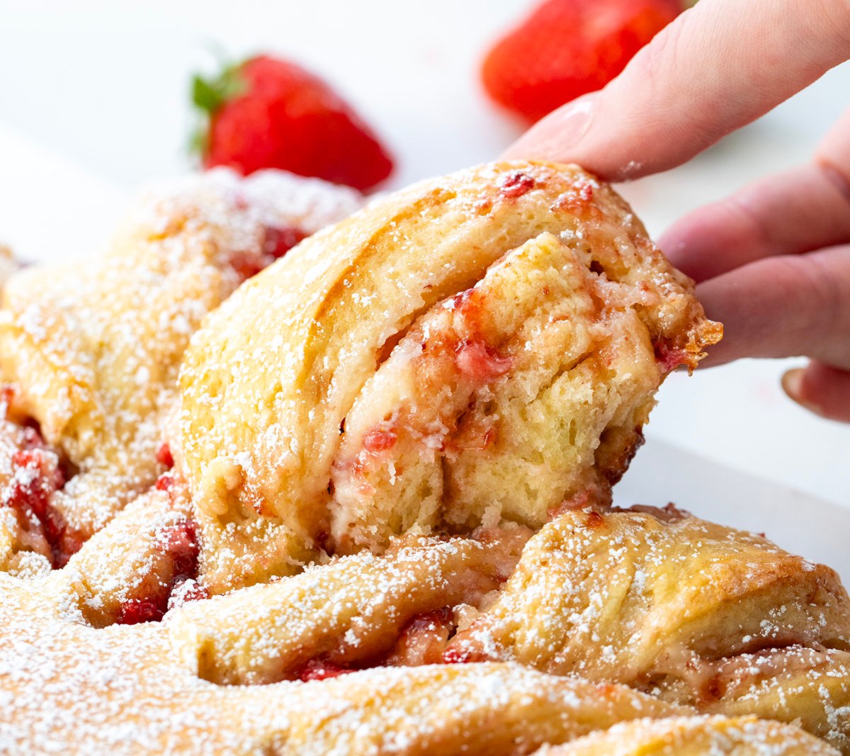 Picking up a piece of Strawberry Heart Bread.