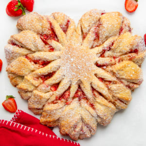 Strawberry Heart Bread on a white counter with strawberries and a red napkin.