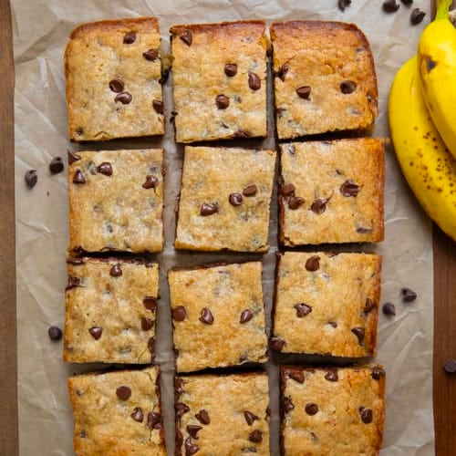 Cut up Banana Chocolate Chip Bars on a wooden table from overhead.