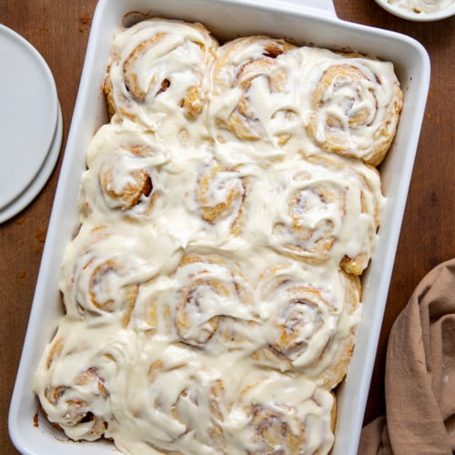 Pan of Biscuit Cinnamon Rolls on a wooden table from overhead.