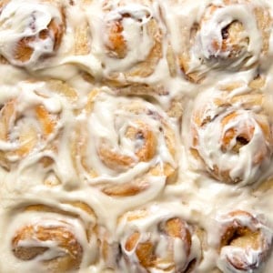 Close up of frosting covered One Hour Cinnamon Rolls from overhead.