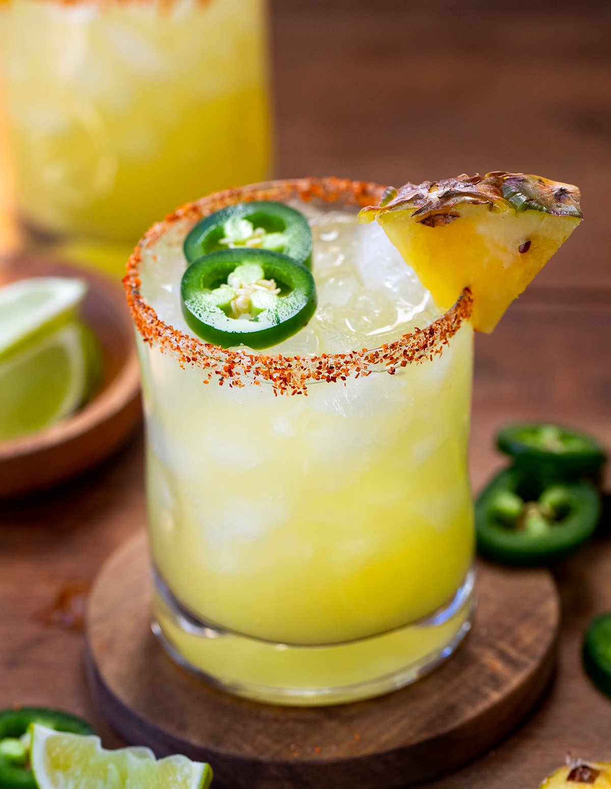 Close up of a glass of Spicy Pineapple Margarita with fresh pineapple and jalapeno.