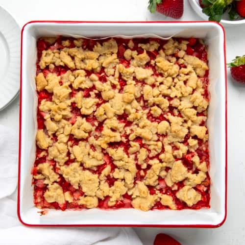 Pan of Strawberry Crumble Bars on a white table from overhead.