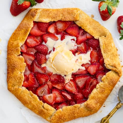 Whole Strawberry Galette on a white table from overhead.