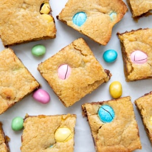 Easter Blondies cut into squares on a white table.