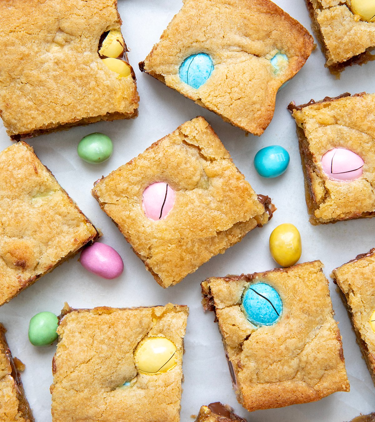 Easter Blondies cut into squares on a white table.