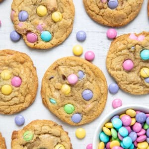 Easter M&M Cookies on a white table with easter pastel M&M's in a white bowl.