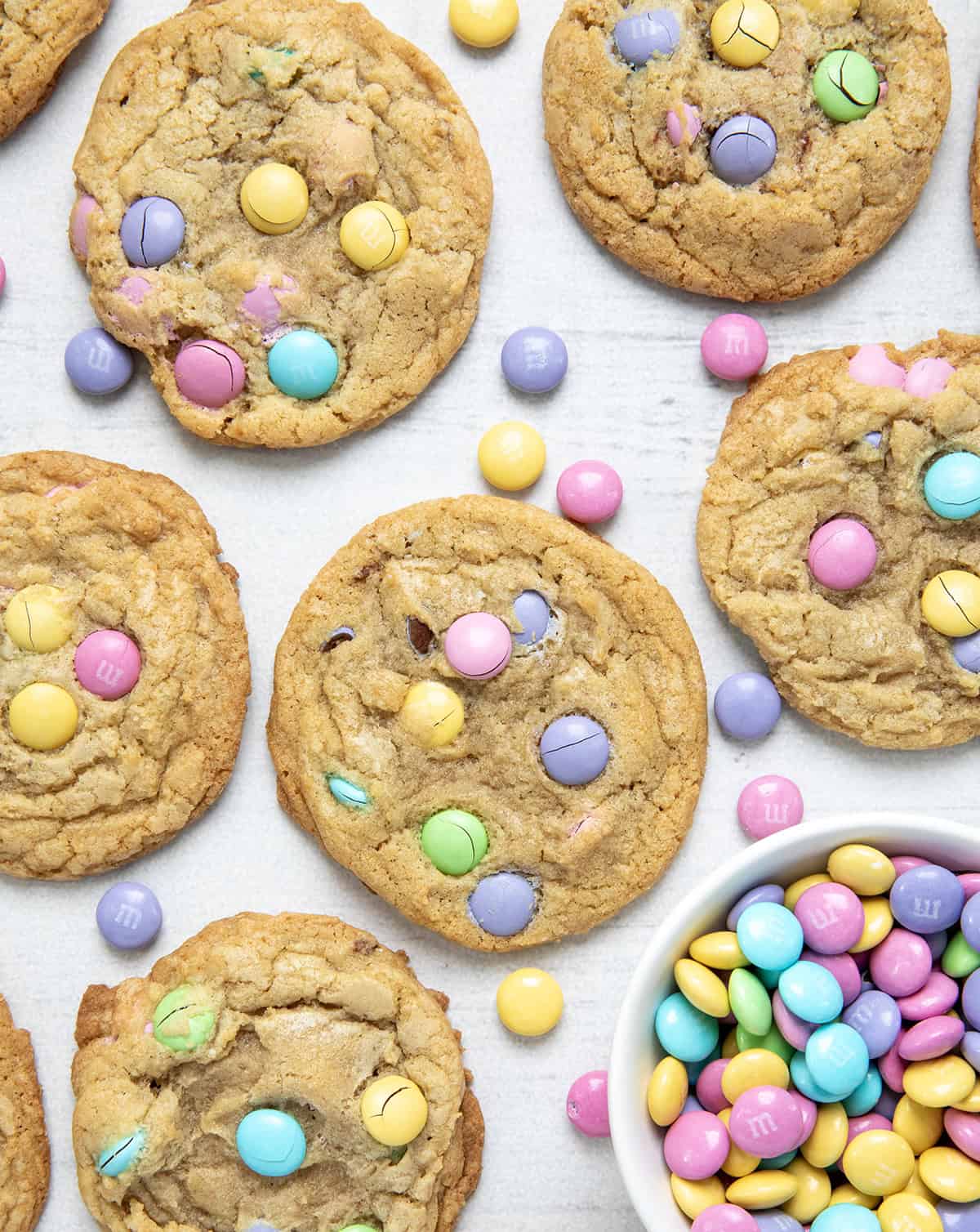 Easter M&M Cookies on a white table with easter pastel M&M's in a white bowl.