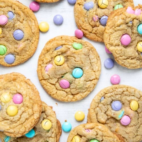 Easter M&M Cookies on a white table from overhead.