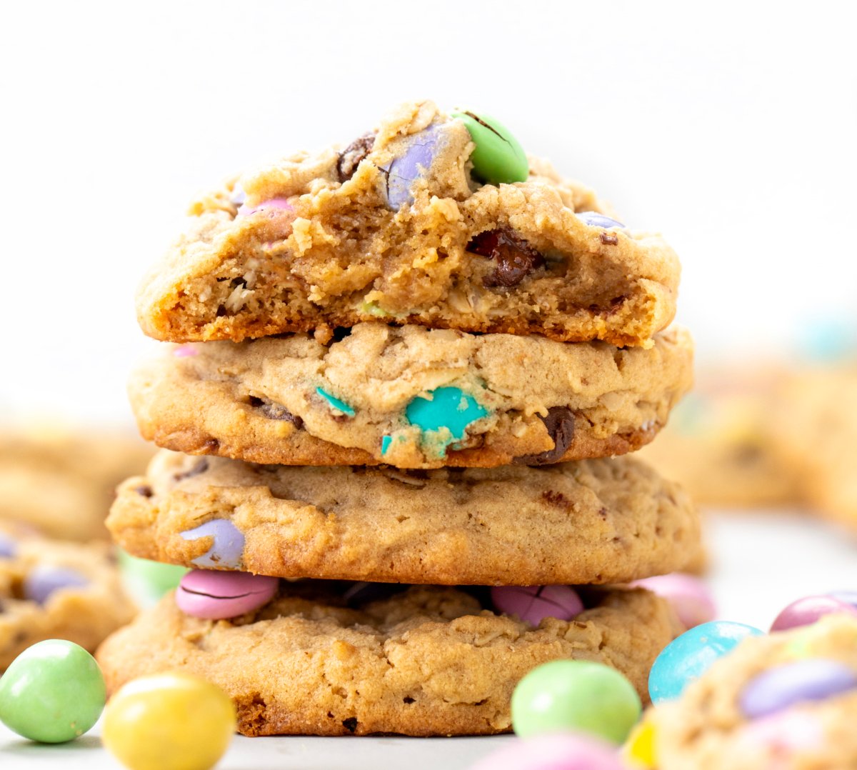 Stack of Easter Monster Cookies with top cookie broken in half showing inside.