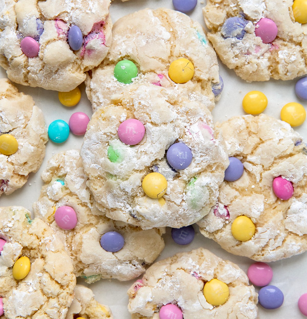 Looking down on a lot of Easter Ooey Gooey Butter Cookies on a white table. 