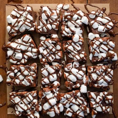 Hot Cocoa Fudge cut into pieces on a wooden table from overhead.