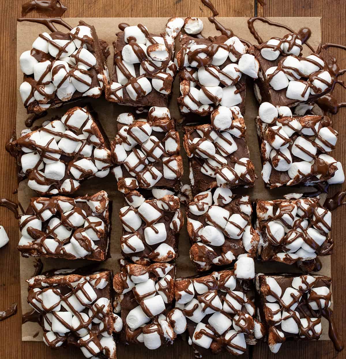 Hot Cocoa Fudge cut into pieces on a wooden table from overhead.