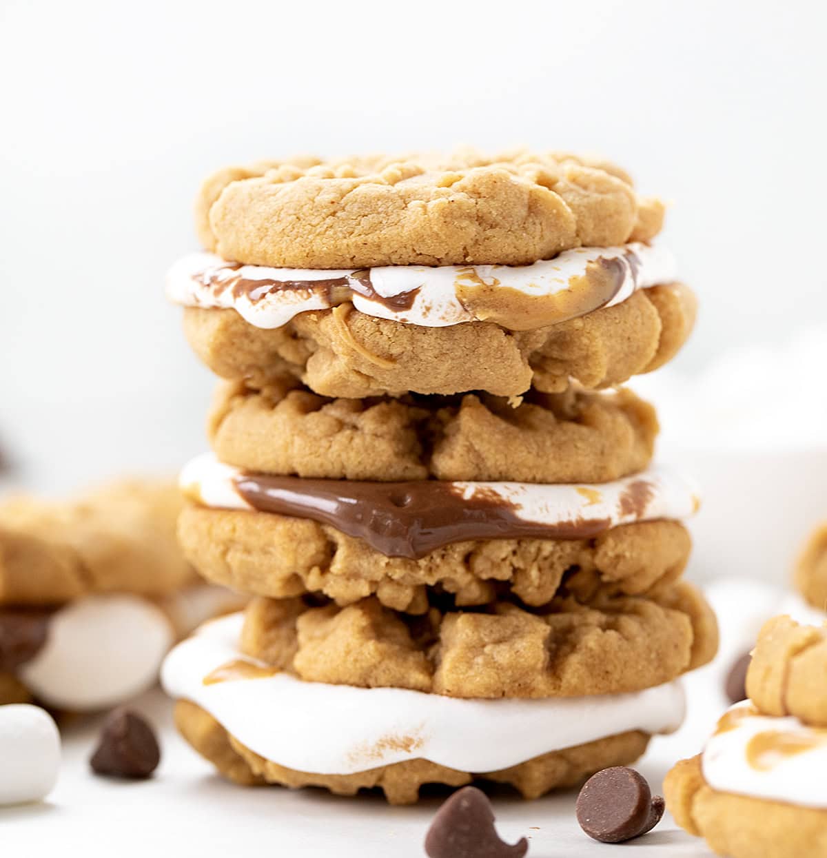 Stack of Peanut Butter S'mores Sandwich Cookies on a white table.