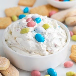 Close up of a bowl of Robin's Egg Dip on a white table.