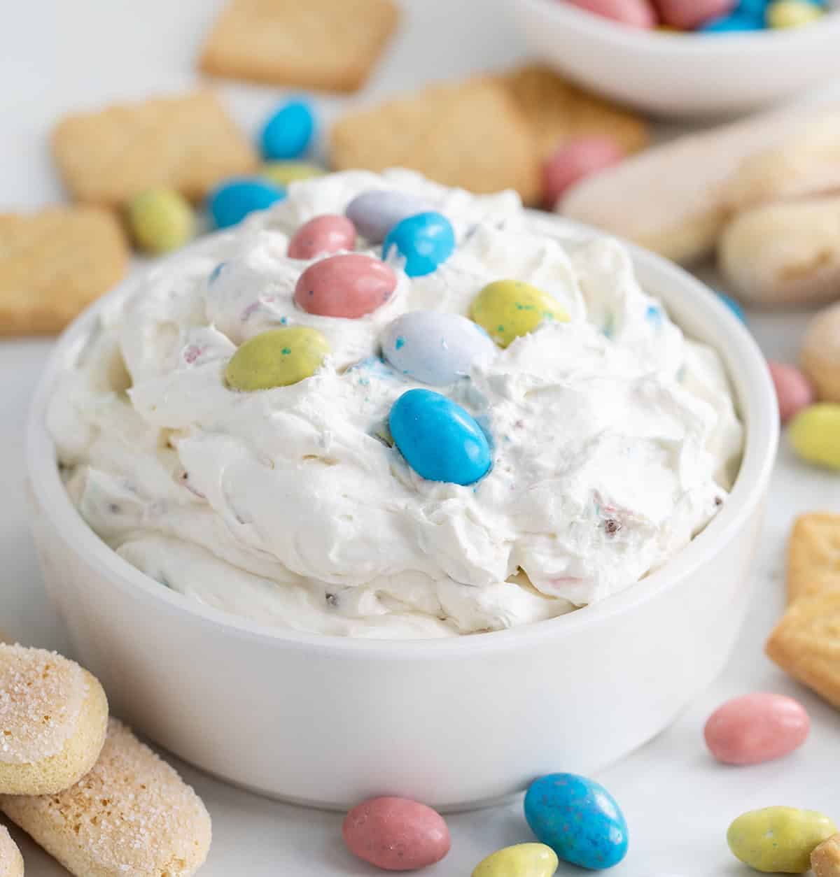 Close up of a bowl of Robin's Egg Dip on a white table.