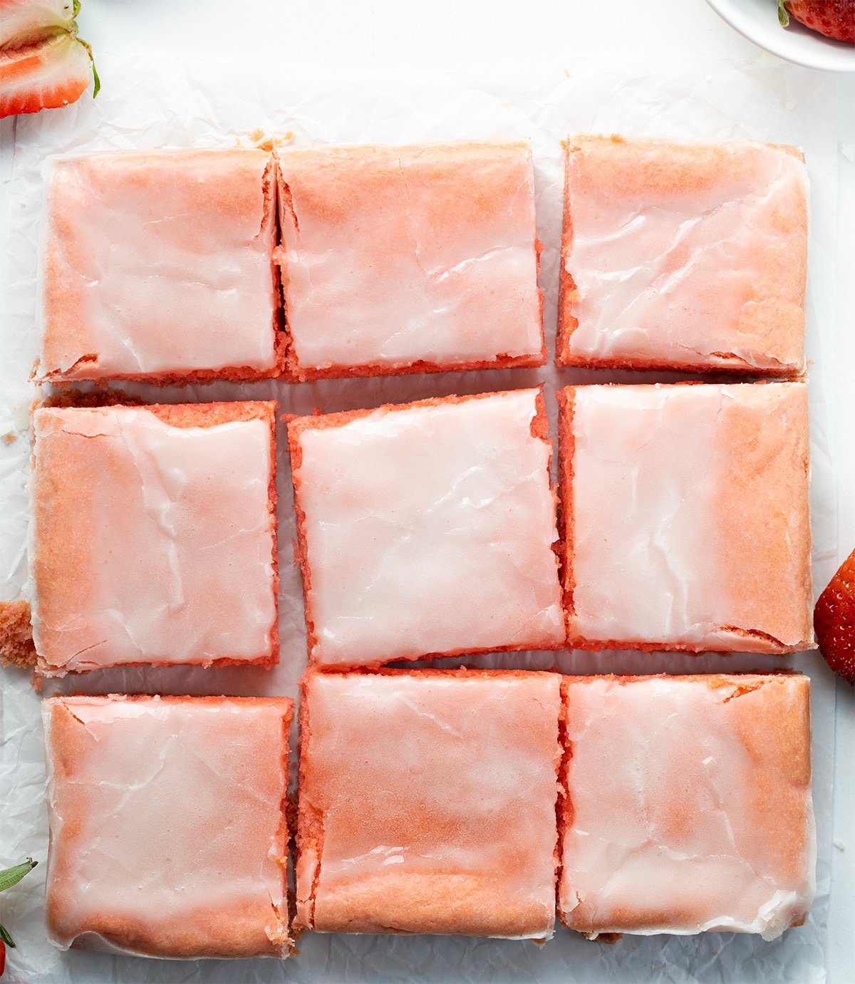 Strawberry Brownies on a white counter cut into squares from overhead.