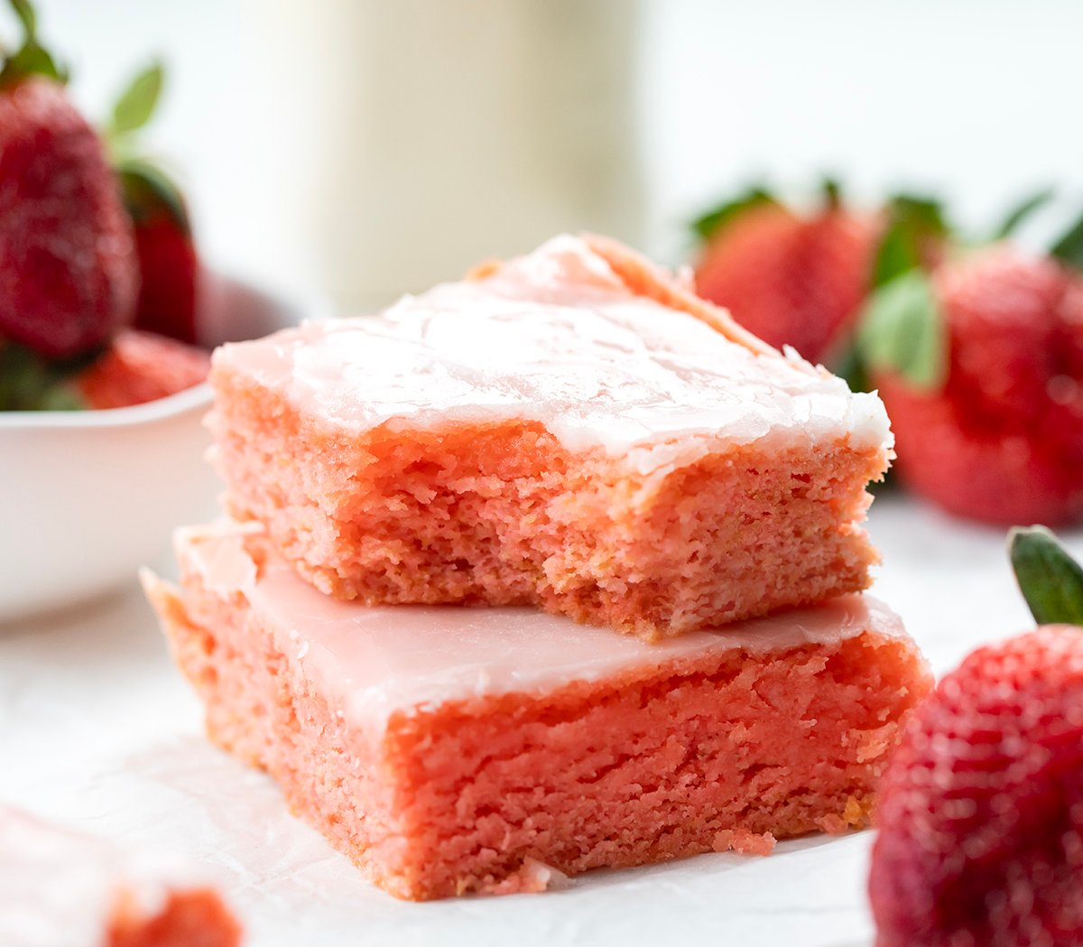 Stack of Strawberry Brownies with top brownie having a bite taken out of it.