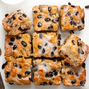 Cinnamon Raisin Butter Swim Biscuits cut into squares on a white table from overhead.